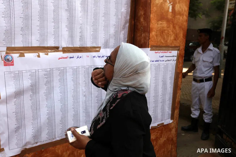 A voter checks her name at a polling station in Cairo June 16, 2012. Egypt's first free presidential election concludes this weekend in a run-off between the Muslim Brotherhood's candidate Mohamed Morsy and Ahmed Shafik,...