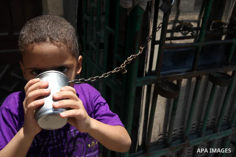 An Egyptian boy drinks water during voting at a polling station in Cairo on June 16, 2012 in a divisive presidential runoff pitting ousted strongman Hosni Mubarak's last premier Ahmed Shafiq against Muslim Brotherhood ca...