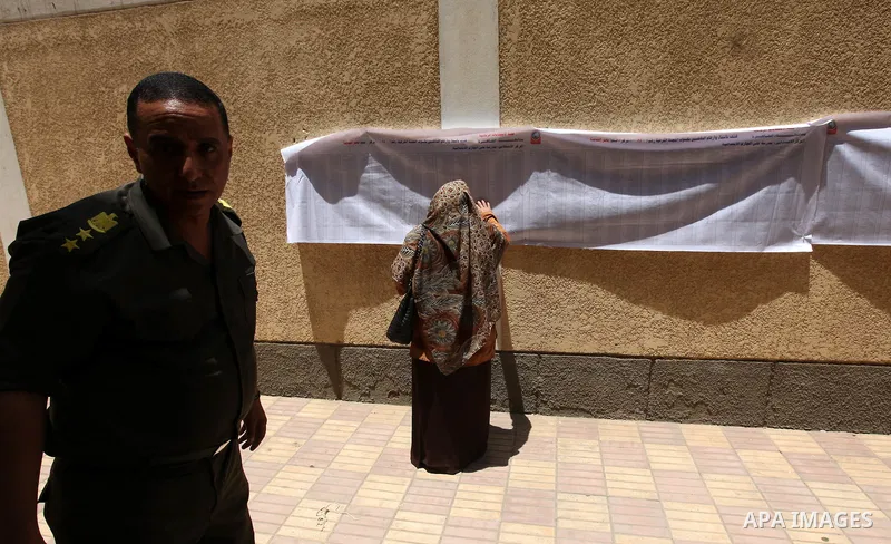 A voter checks her name at a polling station in Cairo June 16, 2012. Egypt's first free presidential election concludes this weekend in a run-off between the Muslim Brotherhood's candidate Mohamed Morsy and Ahmed Shafik,...