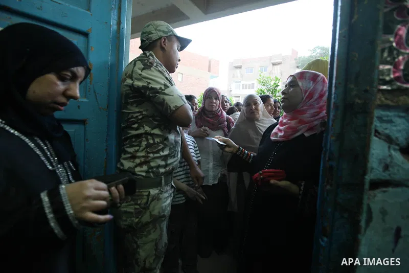 Egyptian women gather to cast their vote in Cairo on June 16, 2012. Egyptians were voting in a run-off presidential election pitting an Islamist against Hosni Mubarak's last premier amid political chaos highlighted by un...