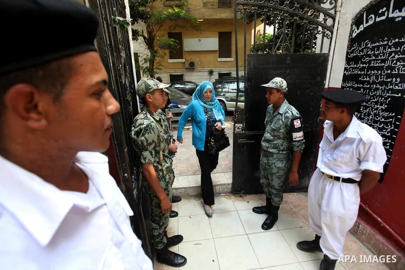 Egyptians solider stand guard outside a polling station in Cairo on June 17, 2012 in a divisive presidential runoff pitting ousted strongman Hosni Mubarak's last premier Ahmed Shafiq against Muslim Brotherhood candidate...