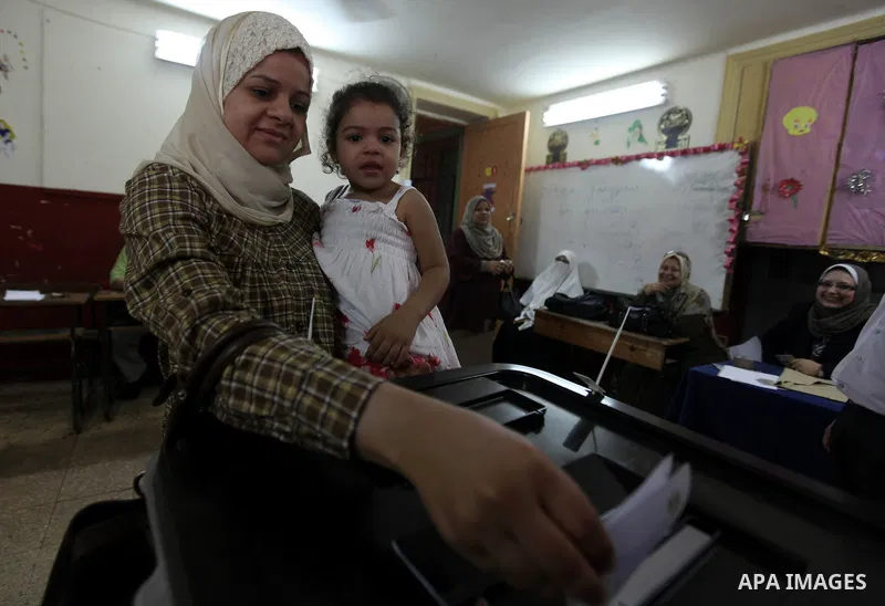 An Egyptian woman votes at a polling station in Cairo on June 17, 2012, as polling opened in Egypt's final day of a divisive election to choose a successor to ousted president Hosni Mubarak, in a race that pits a former...