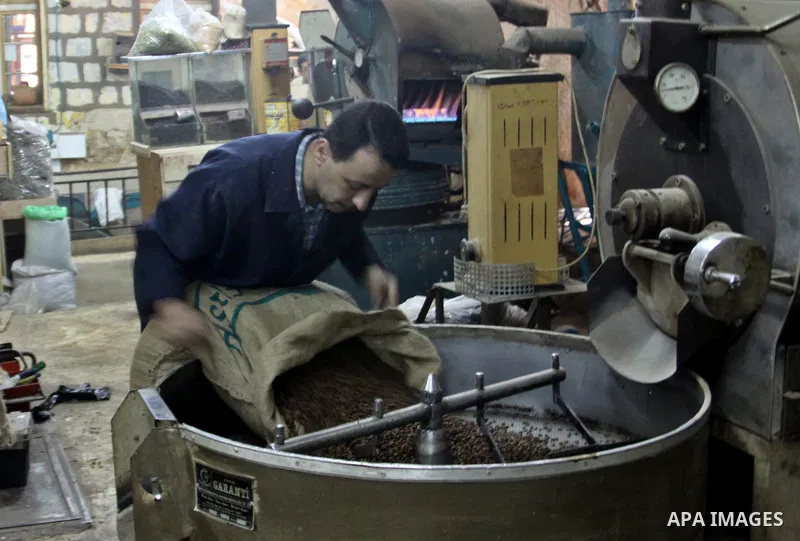 A Palestinian man makes coffe a factory in the West Bank city of Nablus on June 17, 2012. Nablus is famous of manufacturing several different types of spices. Photo by Nedal Eshtayah