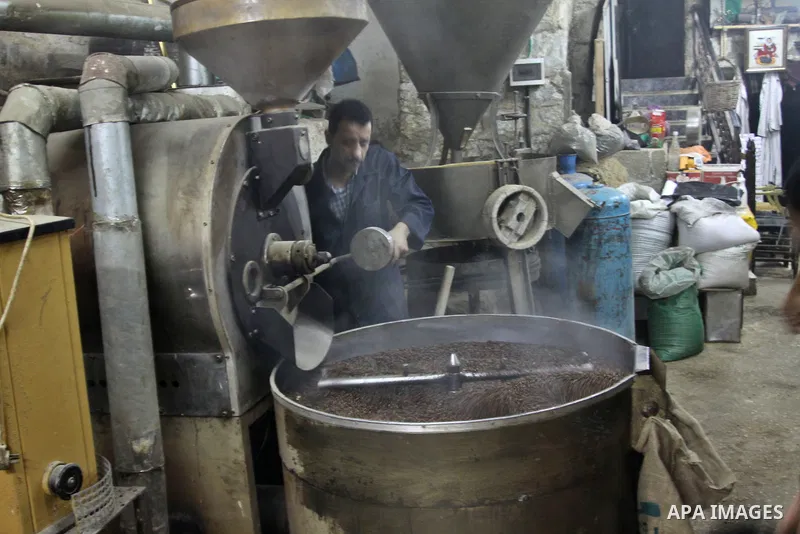A Palestinian man makes coffe a factory in the West Bank city of Nablus on June 17, 2012. Nablus is famous of manufacturing several different types of spices. Photo by Nedal Eshtayah