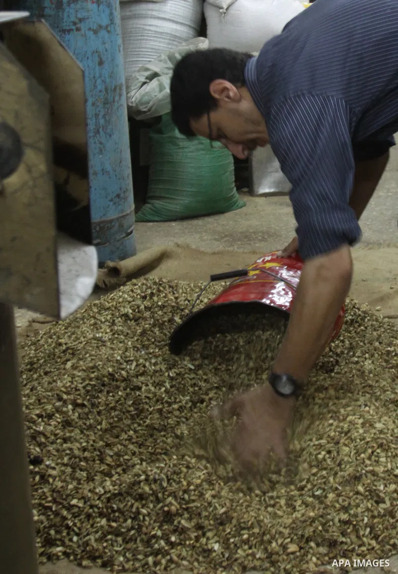 A Palestinian man makes coffe a factory in the West Bank city of Nablus on June 17, 2012. Nablus is famous of manufacturing several different types of spices. Photo by Nedal Eshtayah