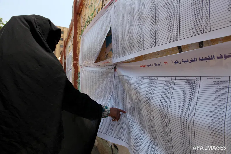 Voters check for their names before casting their votes during the second day of voting in Egypt's presidential election at a polling station in Cairo June 17, 2012. A second day of voting on Sunday will deliver Egypt's...