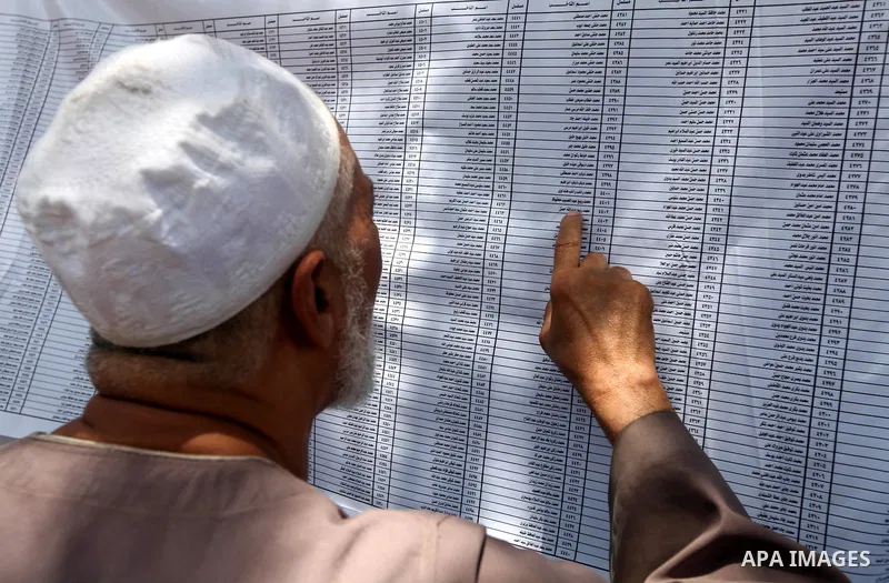 Voters check for their names before casting their votes during the second day of voting in Egypt's presidential election at a polling station in Cairo June 17, 2012. A second day of voting on Sunday will deliver Egypt's...