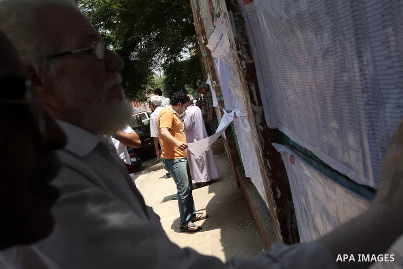 Voters check for their names before casting their votes during the second day of voting in Egypt's presidential election at a polling station in Cairo June 17, 2012. A second day of voting on Sunday will deliver Egypt's...
