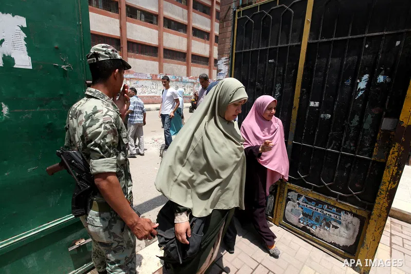 Egyptians solider stand guard outside a polling station in Cairo on June 17, 2012 in a divisive presidential runoff pitting ousted strongman Hosni Mubarak's last premier Ahmed Shafiq against Muslim Brotherhood candidate...