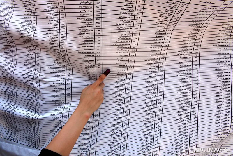 Voters check for their names before casting their votes during the second day of voting in Egypt's presidential election at a polling station in Cairo June 17, 2012. A second day of voting on Sunday will deliver Egypt's...