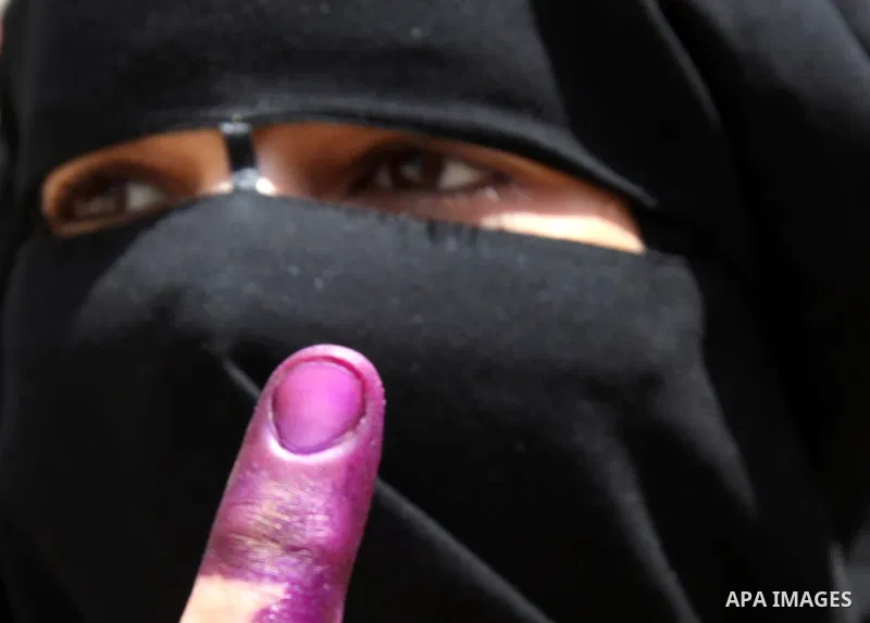 An Egyptian woman shows his ink-stained finger after voting at a polling station in Cairo on June 17, 2012 on Egypt's final day of a divisive election to choose a successor to ousted president Hosni Mubarak, in a race th...