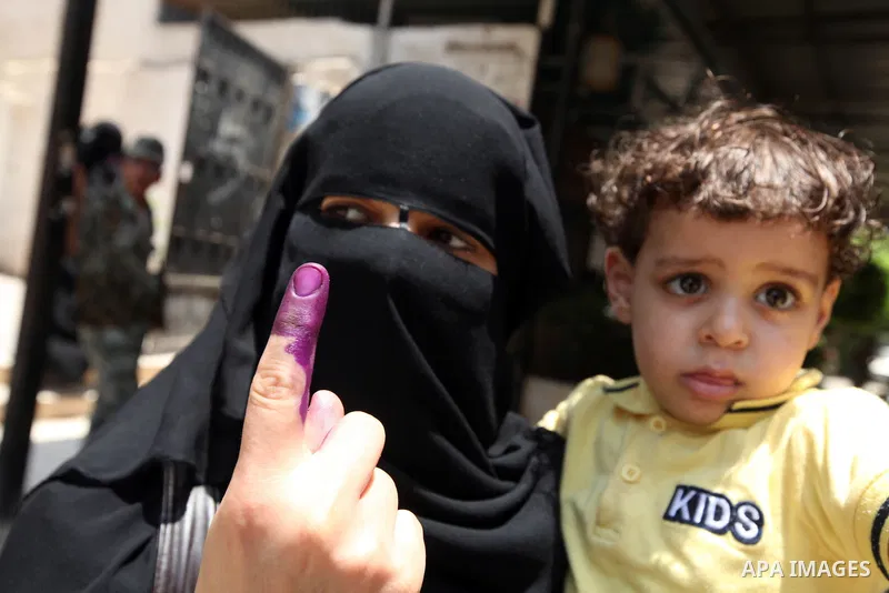 An Egyptian woman shows his ink-stained finger after voting at a polling station in Cairo on June 17, 2012 on Egypt's final day of a divisive election to choose a successor to ousted president Hosni Mubarak, in a race th...
