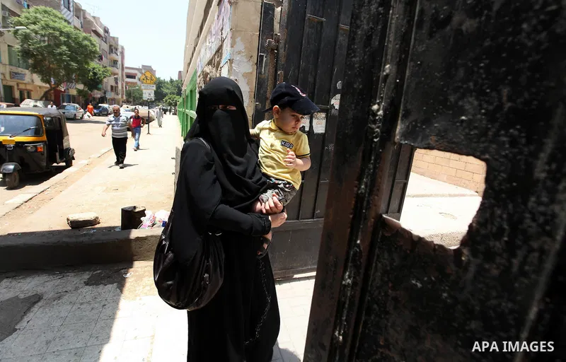 A voter arrives at a polling station to cast her vote during the second day of voting in Egypt's presidential election in Cairo June 17, 2012. A second day of voting on Sunday will deliver Egypt's first freely elected pr...