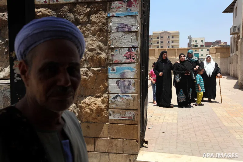 Voter out from a polling station after casting their vote during the second day of voting in Egypt's presidential election in Cairo June 17, 2012. A second day of voting on Sunday will deliver Egypt's first freely electe...