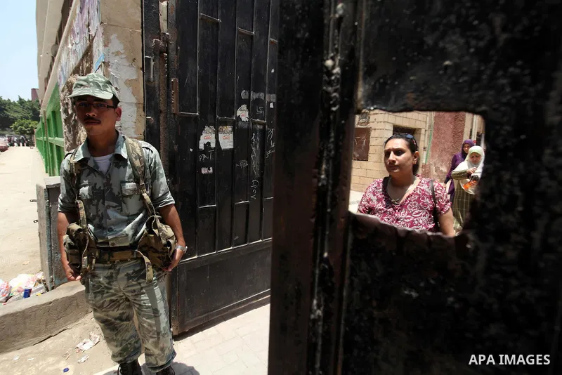 Voter out from a polling station after casting their vote during the second day of voting in Egypt's presidential election in Cairo June 17, 2012. A second day of voting on Sunday will deliver Egypt's first freely electe...