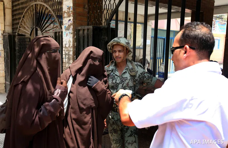 Voter out from a polling station after casting their vote during the second day of voting in Egypt's presidential election in Cairo June 17, 2012. A second day of voting on Sunday will deliver Egypt's first freely electe...