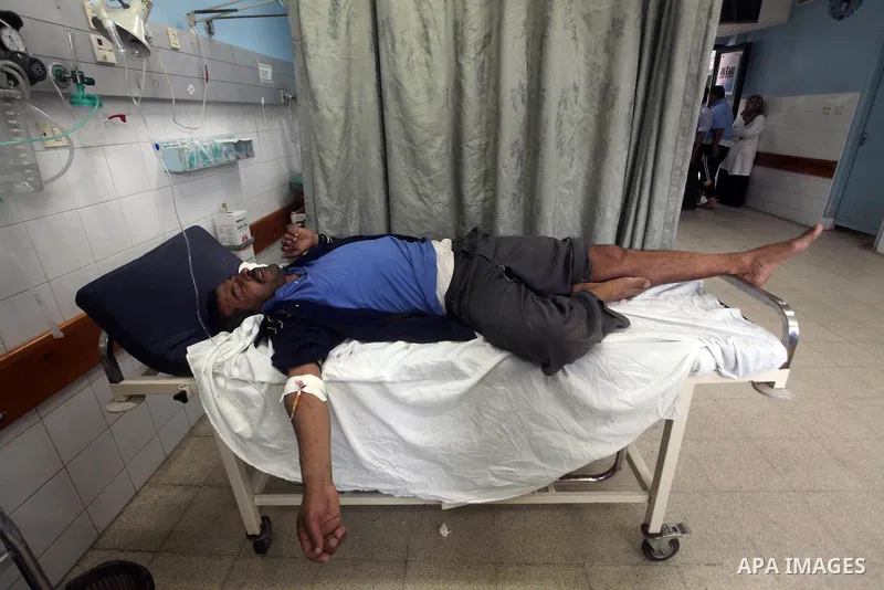 A Palestinian wounded man arrives to Al Aqsa hospital in the central Gaza Strip town of Deir Al Balah, on 17 June 2012. Israeli forces opened fire after incursion Gaza east border about 300 meters. Photo by Ashraf Amra