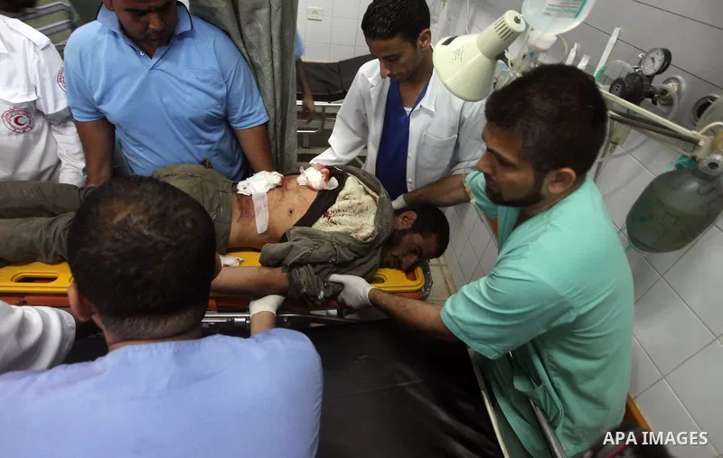 Palestinian medics treat a wounded Palestinian man at al Aqsa hospital in the central Gaza Strip town of Deir Al Balah, on 17 June 2012. Israeli forces opened fire after incursion Gaza east border about 300 meters. Photo...