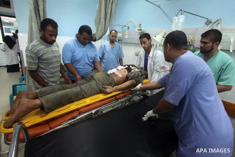 Palestinian medics treat a wounded Palestinian man at al Aqsa hospital in the central Gaza Strip town of Deir Al Balah, on 17 June 2012. Israeli forces opened fire after incursion Gaza east border about 300 meters. Photo...