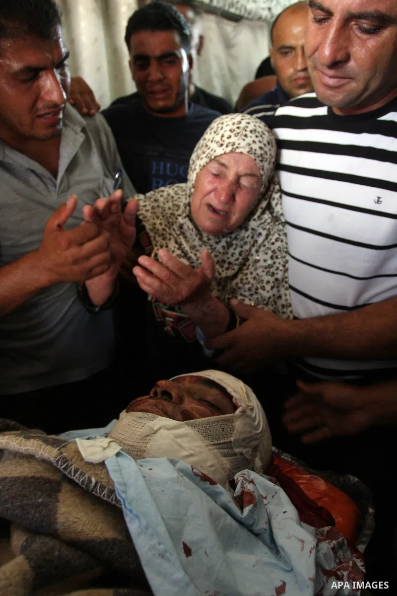 The mother of Naim Najar is surrounded by relatives as they mourn during his funeral in the West Bank village of Idhna, near Hebron, Sunday, June 17, 2012. An Israeli tow truck driver shot dead two Palestinians and wound...