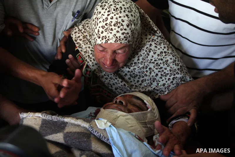 The mother of Naim Najar is surrounded by relatives as they mourn during his funeral in the West Bank village of Idhna, near Hebron, Sunday, June 17, 2012. An Israeli tow truck driver shot dead two Palestinians and wound...