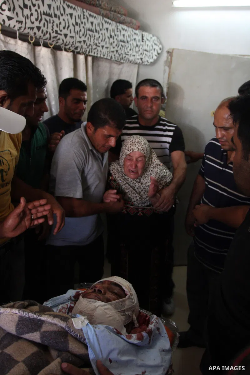 The mother of Naim Najar is surrounded by relatives as they mourn during his funeral in the West Bank village of Idhna, near Hebron, Sunday, June 17, 2012. An Israeli tow truck driver shot dead two Palestinians and wound...