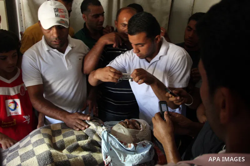 Relatives of Naim al-Najjar, take last pictures for his funeral in the West Bank village of Idhna, near Hebron, Sunday, June 17, 2012. An Israeli tow truck driver shot dead two Palestinians and wounded one Sunday during...
