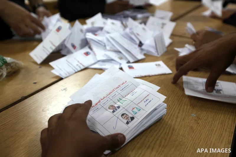 Electoral workers count ballots during the second day of voting in Egypt's presidential election, at a polling station in Cairo June 17, 2012. Egyptians began an anxious wait for their first freely elected president on S...