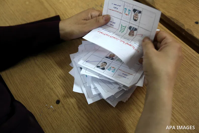 Electoral workers count ballots during the second day of voting in Egypt's presidential election, at a polling station in Cairo June 17, 2012. Egyptians began an anxious wait for their first freely elected president on S...