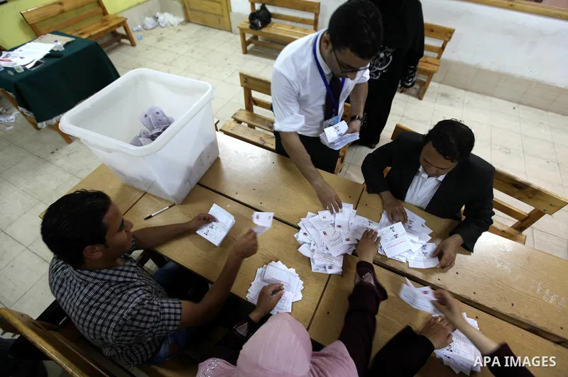 Electoral workers count ballots during the second day of voting in Egypt's presidential election, at a polling station in Cairo June 17, 2012. Egyptians began an anxious wait for their first freely elected president on S...