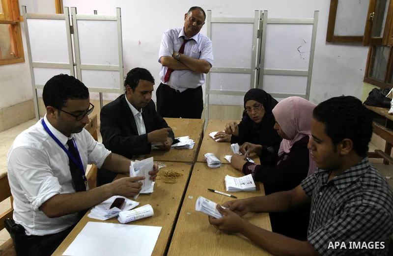 Electoral workers count ballots during the second day of voting in Egypt's presidential election, at a polling station in Cairo June 17, 2012. Egyptians began an anxious wait for their first freely elected president on S...