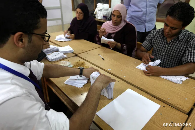 Electoral workers count ballots during the second day of voting in Egypt's presidential election, at a polling station in Cairo June 17, 2012. Egyptians began an anxious wait for their first freely elected president on S...