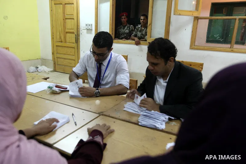Electoral workers count ballots during the second day of voting in Egypt's presidential election, at a polling station in Cairo June 17, 2012. Egyptians began an anxious wait for their first freely elected president on S...