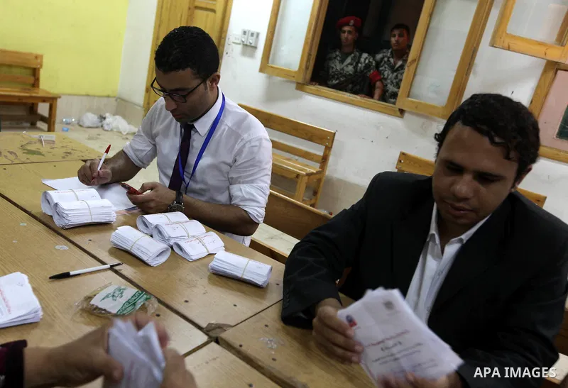 Electoral workers count ballots during the second day of voting in Egypt's presidential election, at a polling station in Cairo June 17, 2012. Egyptians began an anxious wait for their first freely elected president on S...