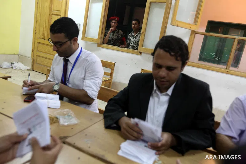 Electoral workers count ballots during the second day of voting in Egypt's presidential election, at a polling station in Cairo June 17, 2012. Egyptians began an anxious wait for their first freely elected president on S...