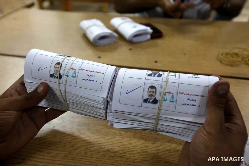 An electoral worker counts ballots voting for Muslim Brotherhood's presidential candidate Mohamed Morsy, after polls closed in Cairo June 17, 2012. Egyptians began an anxious wait for their first freely elected president...