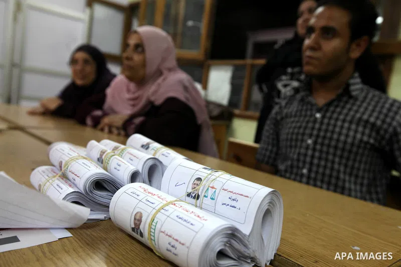 Electoral workers count ballots during the second day of voting in Egypt's presidential election, at a polling station in Cairo June 17, 2012. Egyptians began an anxious wait for their first freely elected president on S...