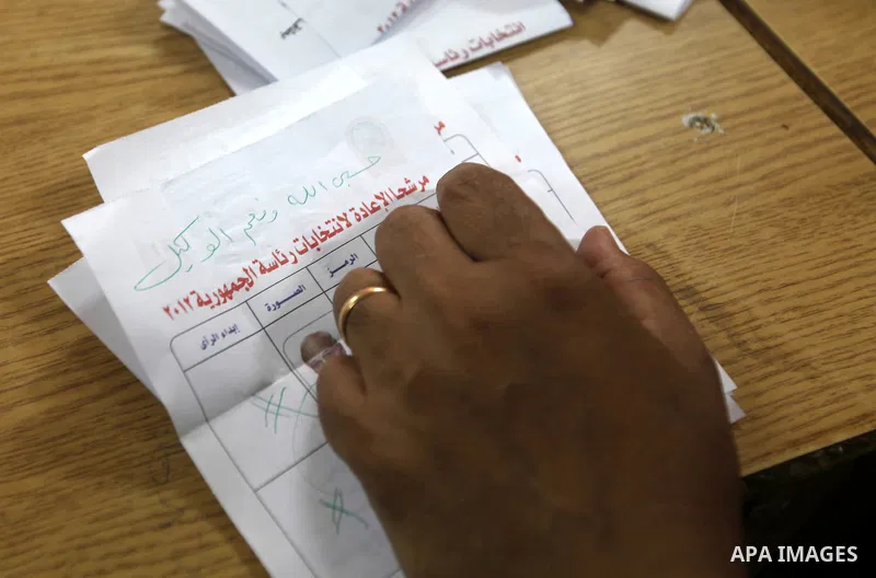 Electoral workers count ballots during the second day of voting in Egypt's presidential election, at a polling station in Cairo June 17, 2012. Egyptians began an anxious wait for their first freely elected president on S...