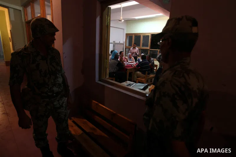 Egyptian soldiers stand alert as election officials count ballots at a polling center on the second day of the presidential runoff, in Cairo, Egypt, Sunday, June 17, 2012. Egyptians voted for a second day Sunday in a pre...