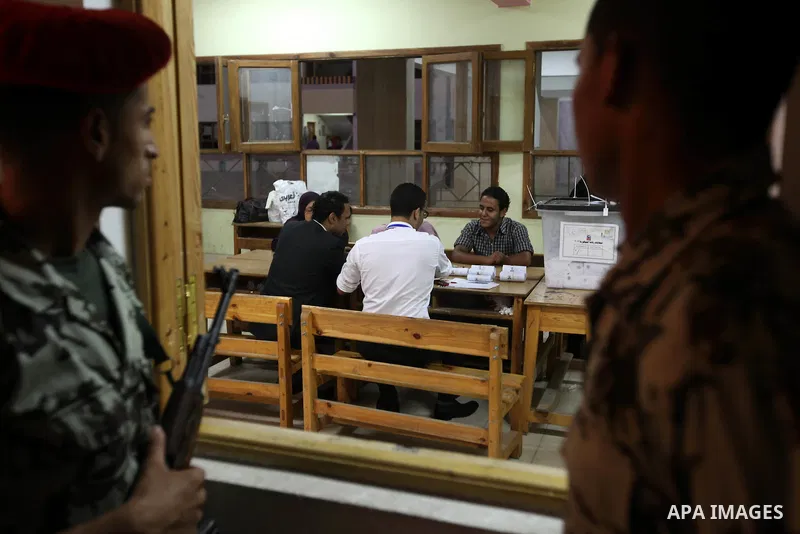 Egyptian soldiers stand alert as election officials count ballots at a polling center on the second day of the presidential runoff, in Cairo, Egypt, Sunday, June 17, 2012. Egyptians voted for a second day Sunday in a pre...