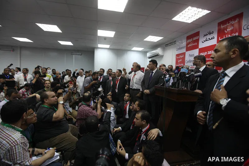 Egypt's Muslim Brotherhood candidate Mohammed Mursi waves amongst his supporters after the announcement of presidential election results at the electoral headquarters in Cairo on June 18, 2012. The campaign of Egyptian p...