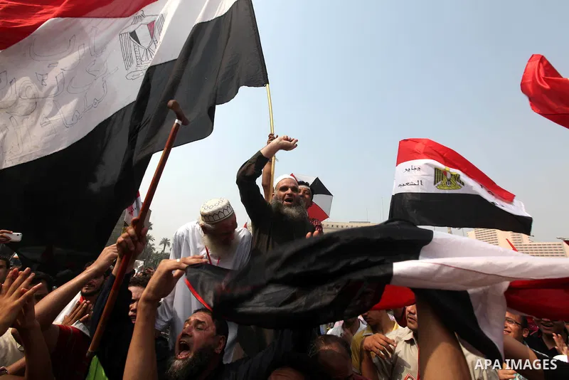 Supporters of presidential candidate Mohammed Morsi carry Egyptian and Muslim Brotherhood flags during celebrations claiming victory in Tahrir Square, Cairo, Egypt, Monday, June 18, 2012. The Muslim Brotherhood declared...