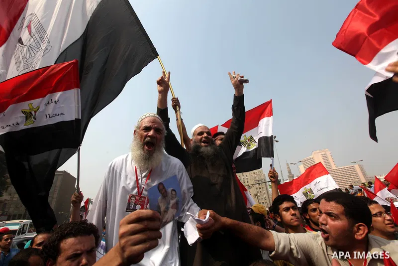 Supporters of presidential candidate Mohammed Morsi carry Egyptian and Muslim Brotherhood flags during celebrations claiming victory in Tahrir Square, Cairo, Egypt, Monday, June 18, 2012. The Muslim Brotherhood declared...