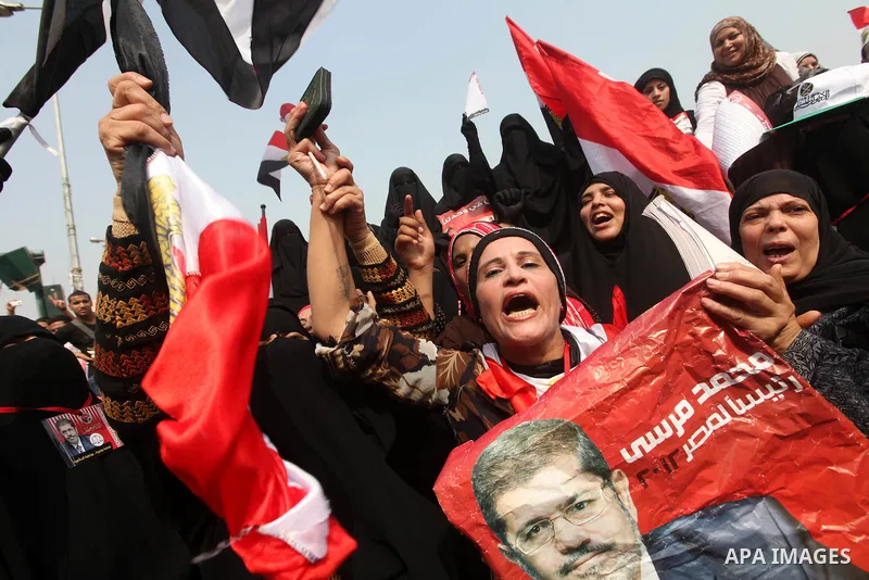 Supporters of presidential candidate Mohammed Morsi carry Egyptian and Muslim Brotherhood flags during celebrations claiming victory in Tahrir Square, Cairo, Egypt, Monday, June 18, 2012. The Muslim Brotherhood declared...