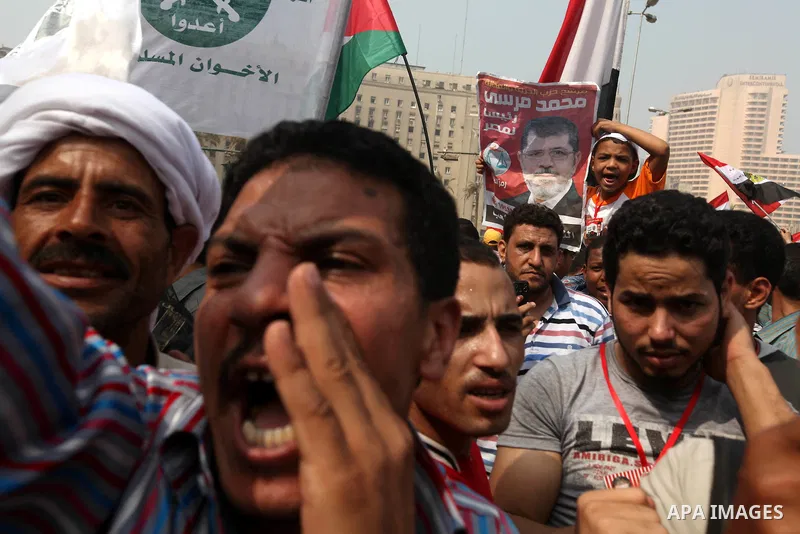 Supporters of presidential candidate Mohammed Morsi carry Egyptian and Muslim Brotherhood flags during celebrations claiming victory in Tahrir Square, Cairo, Egypt, Monday, June 18, 2012. The Muslim Brotherhood declared...