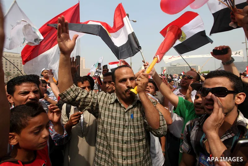 Supporters of presidential candidate Mohammed Morsi carry Egyptian and Muslim Brotherhood flags during celebrations claiming victory in Tahrir Square, Cairo, Egypt, Monday, June 18, 2012. The Muslim Brotherhood declared...