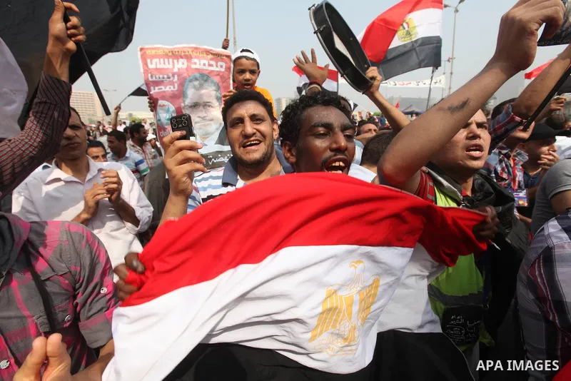 Supporters of presidential candidate Mohammed Morsi carry Egyptian and Muslim Brotherhood flags during celebrations claiming victory in Tahrir Square, Cairo, Egypt, Monday, June 18, 2012. The Muslim Brotherhood declared...
