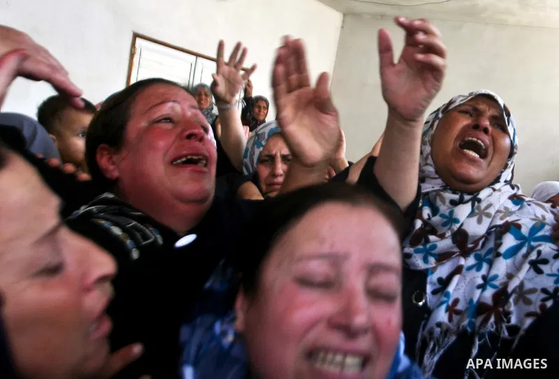 Relatives of Palestinian militant Ismail Odeh mourn during his funeral in Beit Hanun in the northern Gaza Strip on June 18, 2012. Odeh was one of two Palestinians killed in an Israeli strike on north Gaza in the morning,...