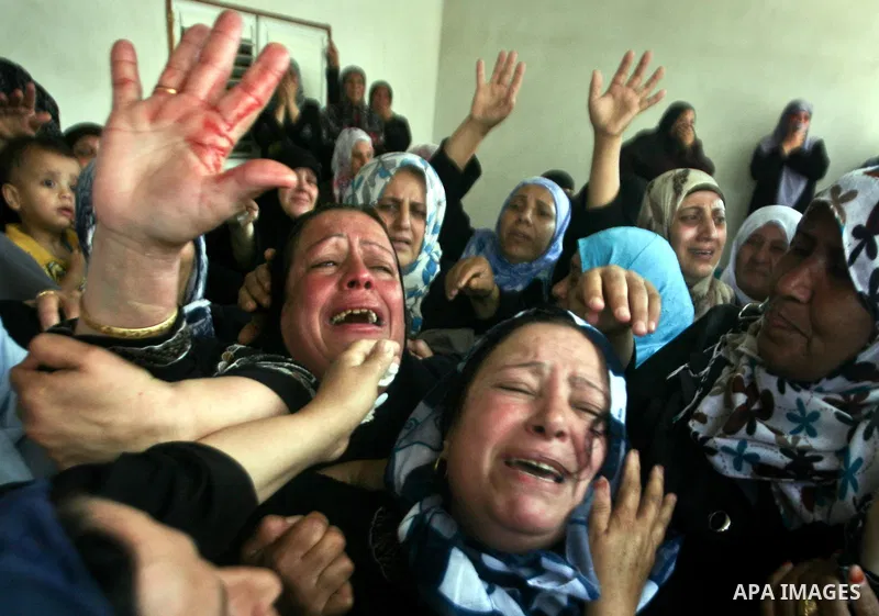 Relatives of Palestinian militant Ismail Odeh mourn during his funeral in Beit Hanun in the northern Gaza Strip on June 18, 2012. Odeh was one of two Palestinians killed in an Israeli strike on north Gaza in the morning,...