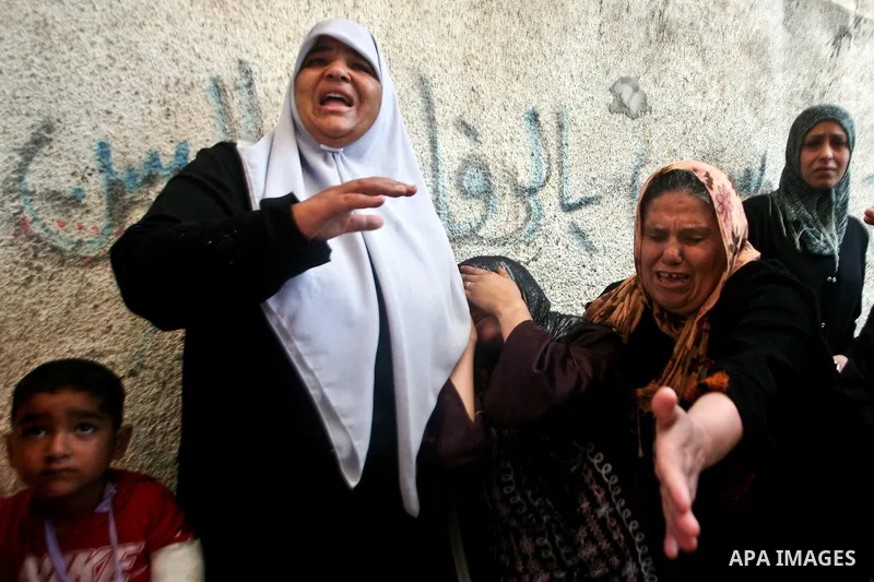 Relatives of Palestinian militant Ismail Odeh mourn during his funeral in Beit Hanun in the northern Gaza Strip on June 18, 2012. Odeh was one of two Palestinians killed in an Israeli strike on north Gaza in the morning,...